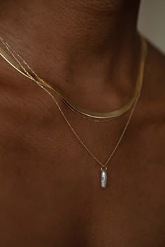 This simple pendant features an elongated sculptural pearl, swinging from a simple gold bail. Wear alone for a simple statement or with others as the perfect layering piece. 14k solid recycled gold Lagniappe Pearl: approximately 11-14mm long x 3.5-4.5mm wide (each pearl is one-of-a-kind and slightly varied), 1.35 cts, responsibly cultured in the Tennessee River Valley, USA Origin Oval jump ring approximately 5mm to slide over most clasps Please note that these charms are sold plain or on our Sig Gold Jewelry Formal, Trendy Diamond Jewelry, Simple Pendant, Gold Layered Necklace, Chic Jewelry Classy, Long Necklaces, Layered Gold Necklaces, Layering Necklaces, Layered Necklace