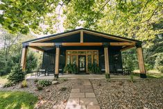 an outdoor pavilion with chairs and trees in the background, surrounded by graveled walkways