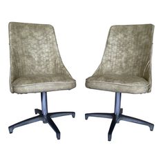 a pair of office chairs sitting next to each other on top of a white background