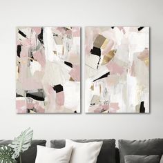 two paintings are hanging on the wall above a couch