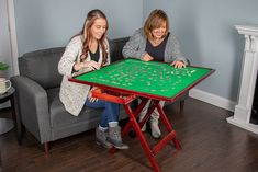 two women sitting at a green table with shamrocks on it