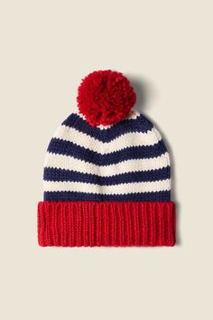 a red, white and blue striped beanie with a pom - pom