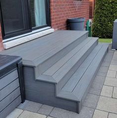 an outdoor deck with steps leading up to the door