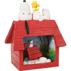 a red house with snoopy and charlie brown on top