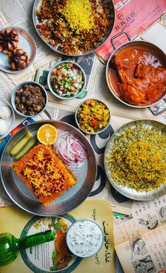 a table topped with lots of different types of food on top of plates and bowls