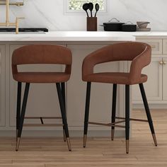 two brown chairs sitting on top of a kitchen counter