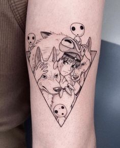 a woman's leg with an image of two wolfs and three aliens on it