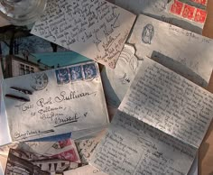 letters and envelopes are piled on top of each other