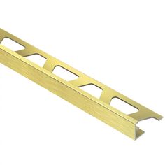 a gold metal strip with holes in the middle