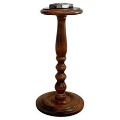 a small wooden table with a ring on it's top and an object in the middle