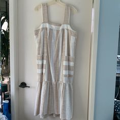 New With Tags White And Tan Stripes Loose-Fitting With Side Pockets Pit To Pit 20” Shoulder Strap To Hem Is 45.5” Cotton/Acrylic Flounced Skirt, Square Neckline Would Be Perfect For A Beach Wedding, Outdoor Picnic, Or Outdoor Bridal Shower. Size Tag Says Petite Large But Regular Large Would Fit Just Fine Too! Neutral Cotton Beach Dress, White Linen Sundress For Brunch, White Linen Sundress For Day Out, White Cotton Midi Dress For Beach Season, Cream Sundress For Vacation, Unlined Sundress Midi Dress For Vacation, Beige Knee-length Sundress For Beach, Neutral Summer Midi Dress For Brunch, Neutral A-line Midi Dress For Summer