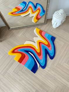 a colorful rug on the floor next to a mirror