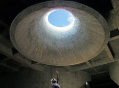 a man reaching up into the air to catch a frisbee in his hand