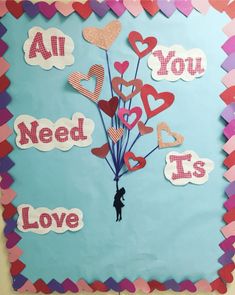 a bulletin board with hearts and the words all you need is love