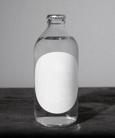 a bottle filled with water sitting on top of a wooden table