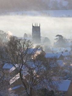 the town is covered in snow and fog