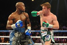 two men in boxing gear standing next to each other