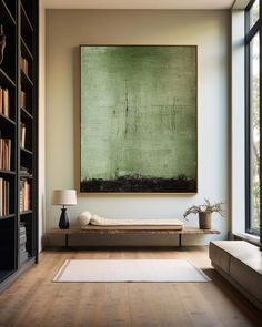 a large painting hanging on the wall above a bed in a room with wooden floors