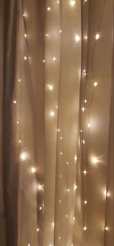 the curtains are covered with white lights