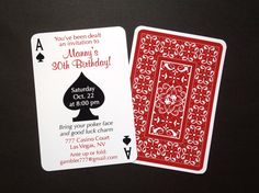 two playing cards with red and white designs on them