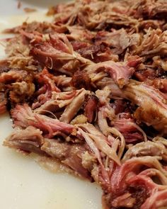 shredded meat sitting on top of a cutting board