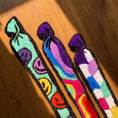 three colorful skis sitting on top of a wooden floor