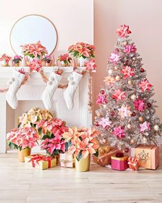 a decorated christmas tree in front of a fireplace