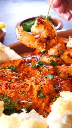 A hand holding a cooked shrimp up, about to dip it in some romesco sauce Spanish Shrimp Recipes, Seafood Tapas, Spanish Menu, Shrimp Meals, Spanish Tapas Recipes, Fish Dinner Recipes, Shrimp Sauce, Romesco Sauce, Yummy Seafood