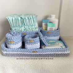 a crocheted basket with toiletries and soaps on the counter next to it