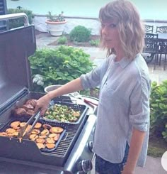 a woman grilling food on an outdoor grill