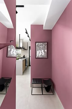 a room with pink walls and white flooring in the center is an art piece