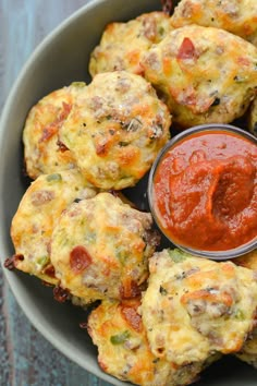 a bowl filled with mini pizzas covered in ketchup