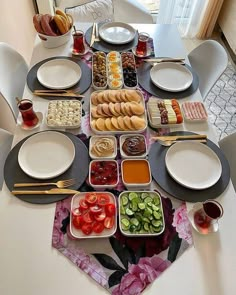 the table is set with many different types of food