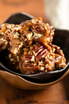 a bowl filled with pecans and chocolate covered pretzels