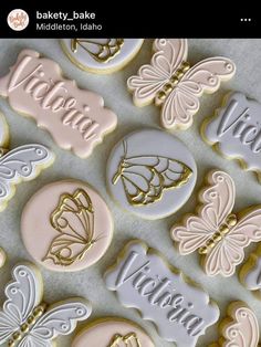 decorated cookies with name and butterflies are displayed on a table in front of the camera