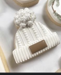 decorated cookies with frosting and decorations on white tablecloth, closeup view from above