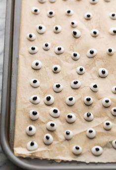 there are many fake eyeballs on the baking sheet that is ready to go into the oven