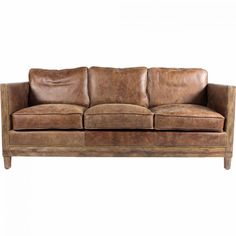 a brown leather couch sitting on top of a white floor next to a wooden frame