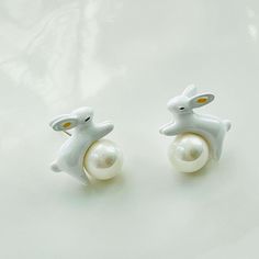 Hop into a whimsical world with our cute Enamel White Rabbit Pearl Stud Earrings. Our charming earrings feature a white bunny leaping over a pearl, making them the perfect accessory for those who love playful and adorable jewelry. This pair is inspired by both the charming nature of bunny and the timeless elegance of pearl. We have matching rabbit necklace, bracelet and ring available. The set will be packed with a box when you buy them. Weight: 5g per each Dimension: 1.8cm*1.9cm Materials: Enam Bunny Bracelet, Bunny Jewelry, Rabbit Necklace, Rabbit Jewelry, Rabbit Earrings, Rabbit Necklaces, Easter Jewelry, White Bunny, White Rabbit