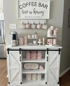 a coffee bar with cups and mugs on it