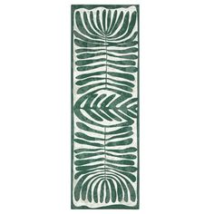 a long green and white rug with leaves on it's side, in the shape of a rectangle