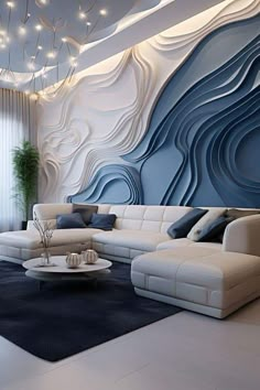 a living room with white couches and blue wall paper on the walls behind them