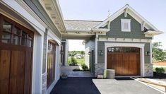 a large house with two garages in front of it