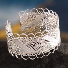 Superbly crafted in the style of Catacaos this cuff bracelet is inspired by colonial treasures. Alfredo Inga creates frothy ocean waves that surround the wrist like lace. He works in Andean silver creating the filigree images with strands of fine silver. .999 and .925 silver Luxury Filigree Cuff Bracelet For Formal Occasions, Elegant Cuff Bracelet With Intricate Design, Ornate Adjustable Cuff Bracelet With Intricate Design, Adjustable Ornate Cuff Bracelet With Intricate Design, Elegant Cuff Jewelry With Intricate Design, Unique Adjustable Bracelets With Intricate Design, Artisan Jewelry Bangle With Intricate Design, Bohemian Adjustable Cuff Bracelet With Intricate Design, Adjustable Filigree Bangle Bracelet