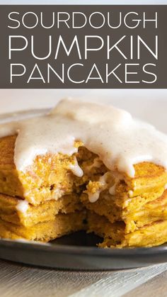 a close up of a plate of food with a bite taken out of it and the words, sourdough pumpkin pancakes