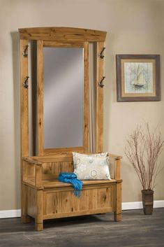 a wooden bench sitting under a mirror in a room