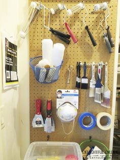 a pegboard with various tools hanging on it