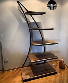 a set of three shelves sitting on top of a hard wood floor