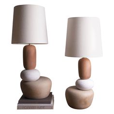 two lamps with rocks stacked on top of each other