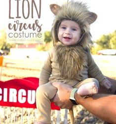 a man holding a small child wearing a lion costume on top of his head and the caption reads, lion circus costume